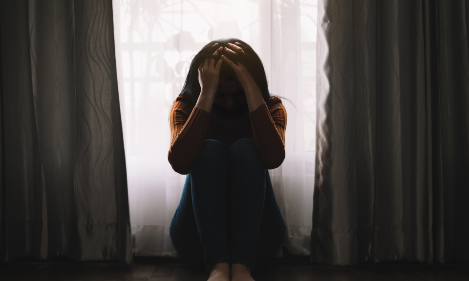 Person sitting in dark room